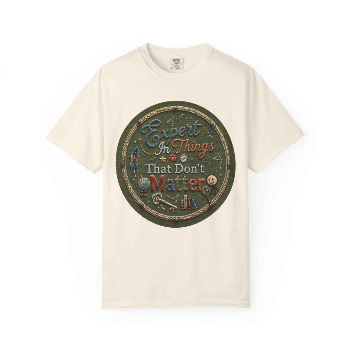 Color: Ivory | Expert In Things That Don't Matter Unisex Garment-Dyed Tee